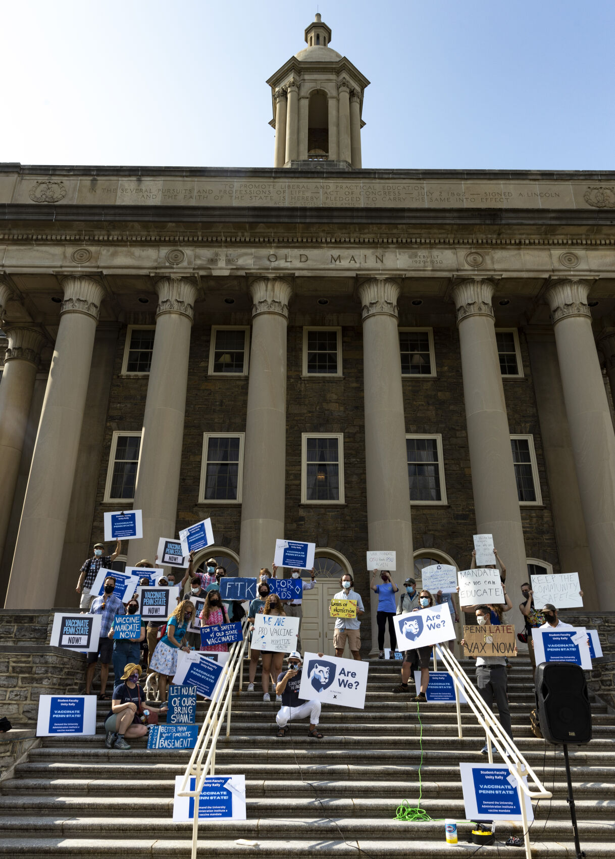 Rally to Vaccinate Penn State, signs on Old Main steps
